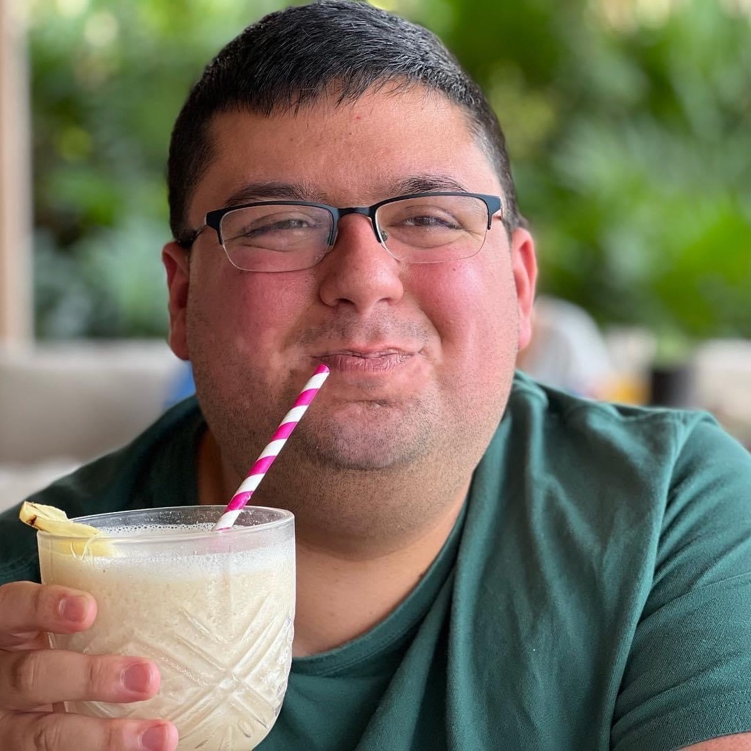 A photo of me holding a piña colada.